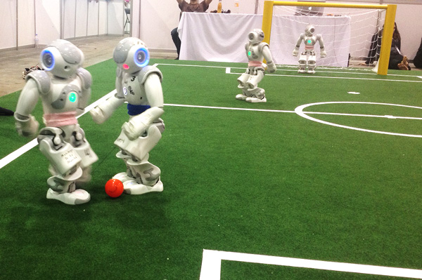 The UT Austin Villa RoboCup Team (pink) playing at the 2012 Robot Soccer World Cup in Mexico City.