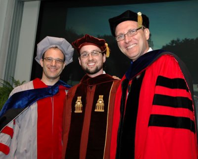 Donald Porter (Center) celebrates his graduation from UTCS with Associate Professor Emmett Witchel (Left) and Professor Lorenzo Alvisi (Right) at the 2011 UTCS Ph.D. Hooding Ceremony.
